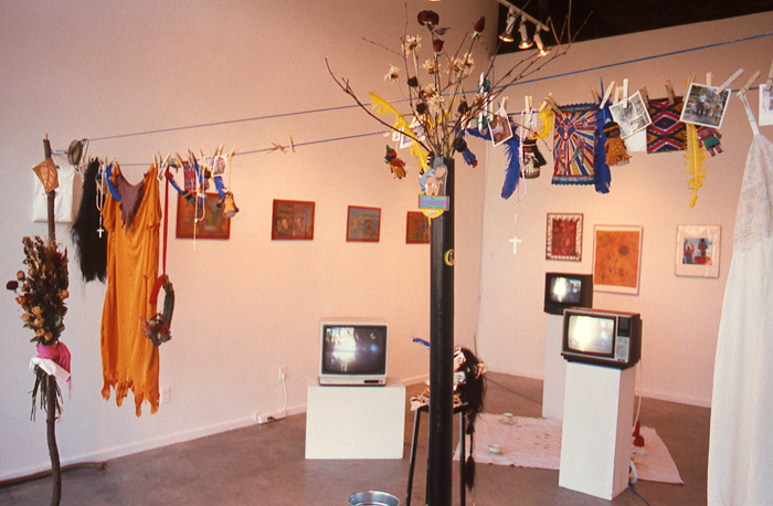 1998_01_30_Performance_Positive_Series_The_Stone_Show_slide_23_grunt_installation_three_TV_monitors_on_plinths_clothes_hanging_prints_on_wall_Zachery_Longboy
