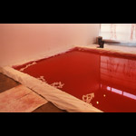 “Rubicon” - installation view blood pool rubber boots