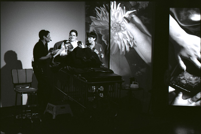 Persimmon Blackbridge, Lizard Jones and Susan Stewart with a projection of a daisy